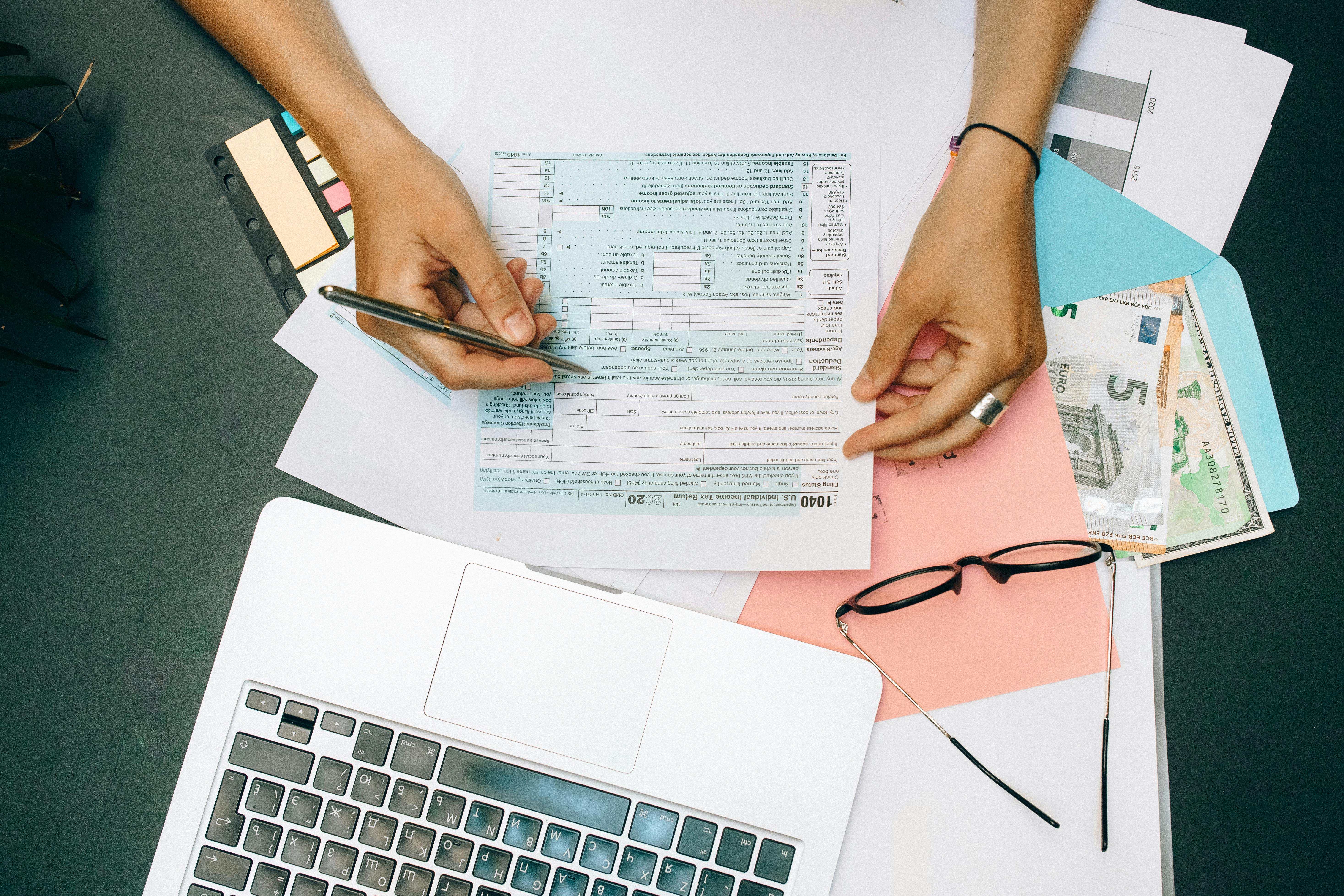 Tax preparation documents and forms on desk showing careful filing process