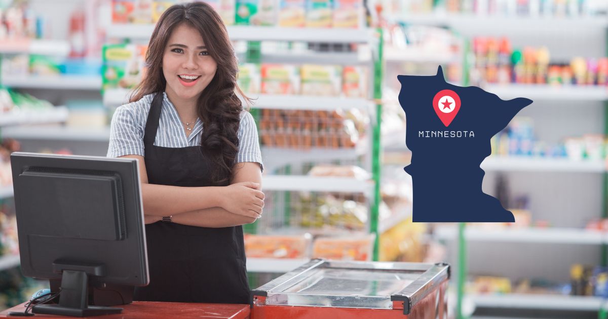 Woman standing in front of a cash register with a Minnesota logo in frame