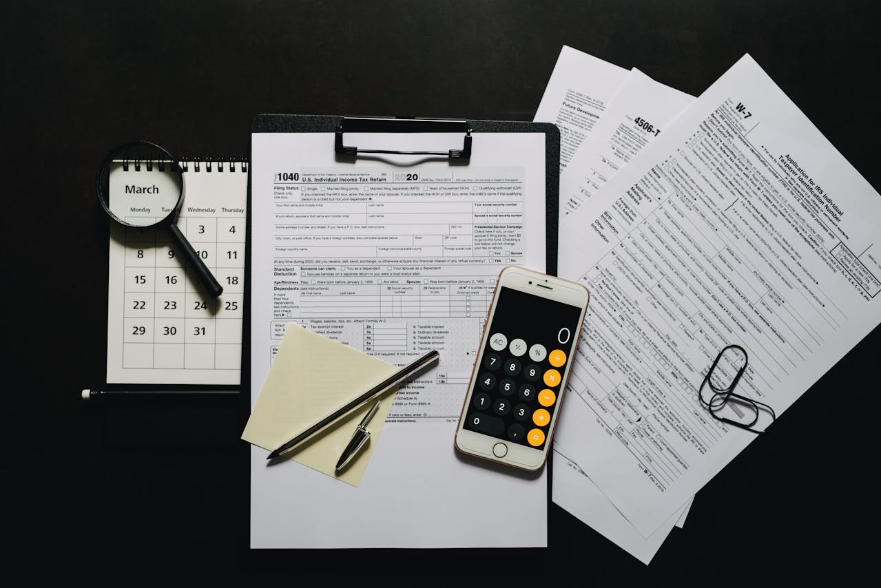 Smartphone on a clipboard with blank tax forms