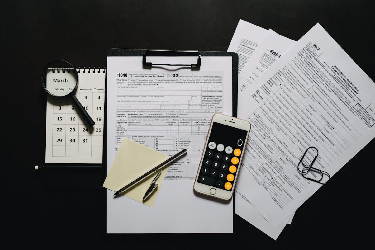 Smartphone on a clipboard with blank tax forms