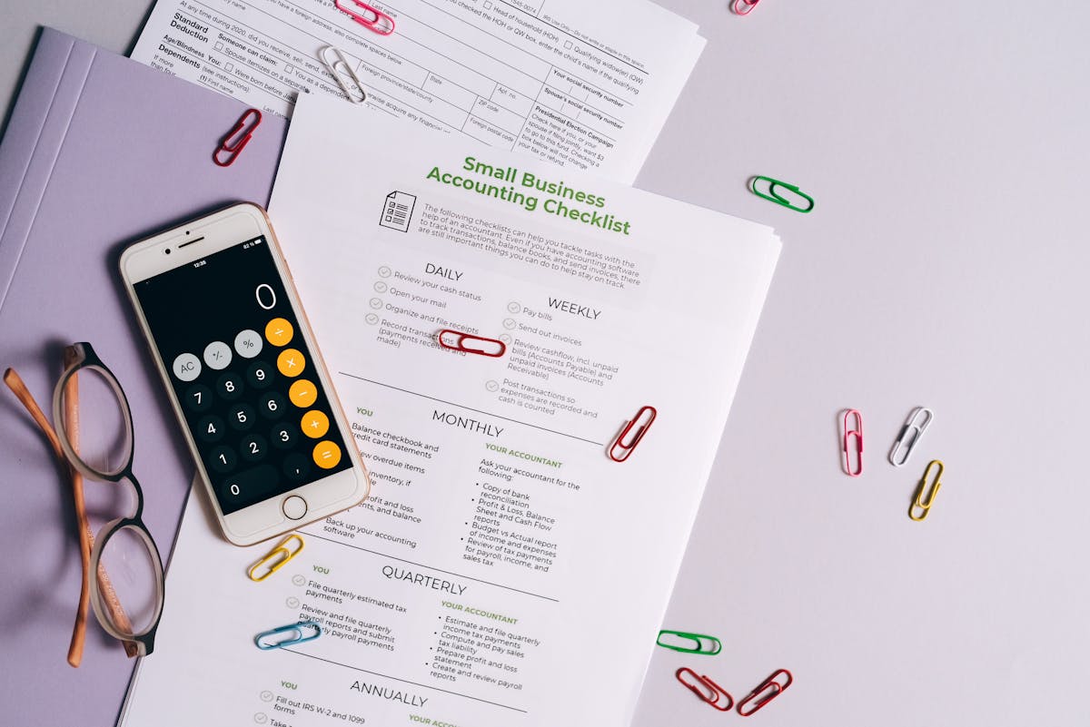 Paperclips and paperwork on a flat surface, representing business expense organization