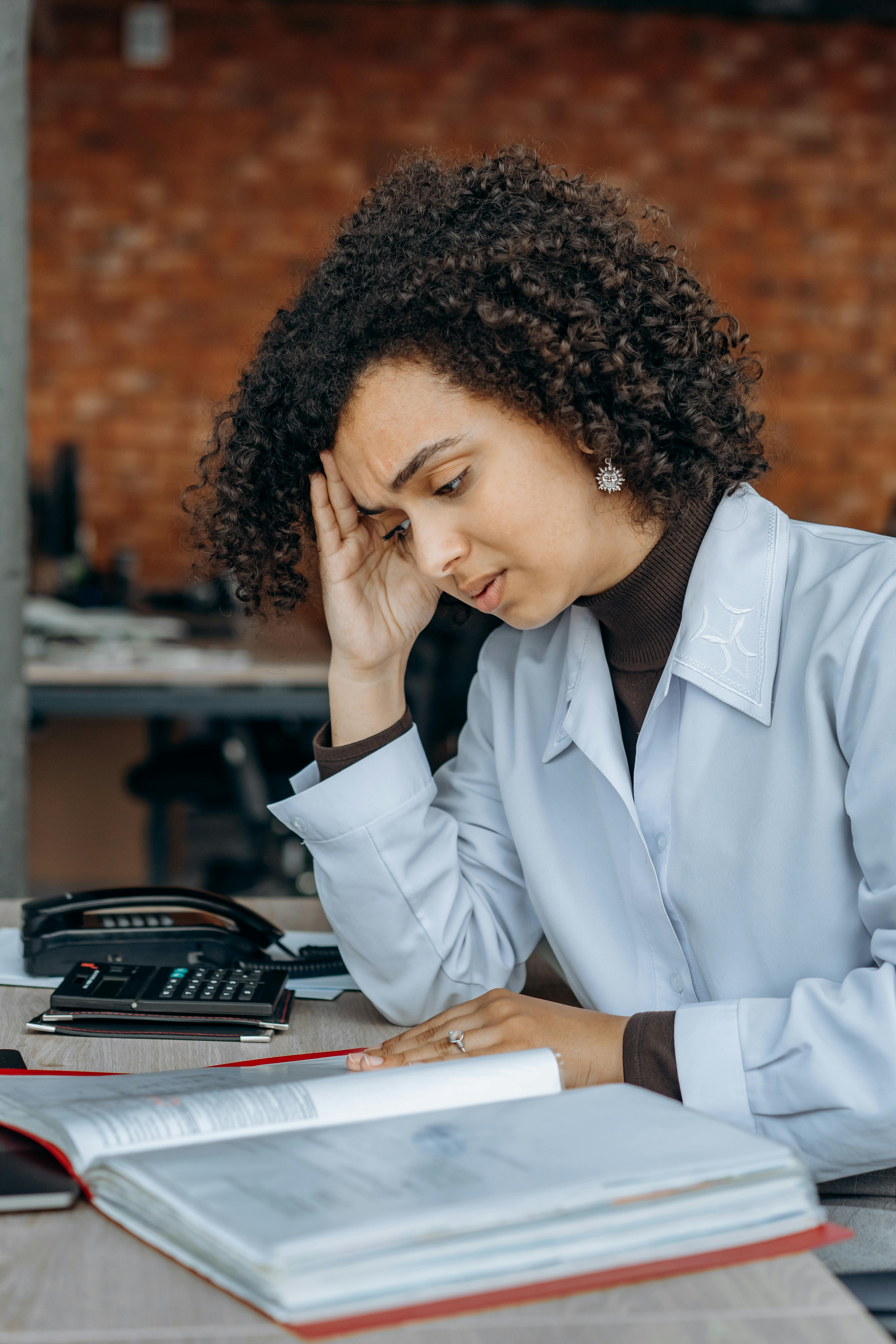 An exhausted woman reading files