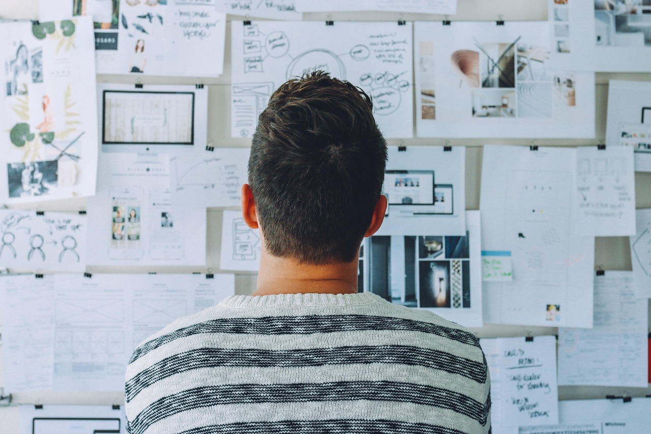 Business owner looking at papers on a whiteboard