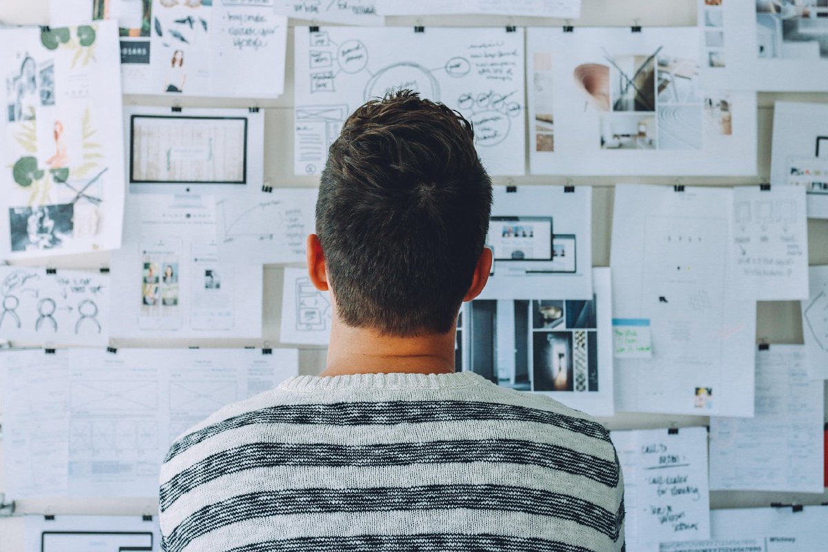 Business owner looking at papers on a whiteboard
